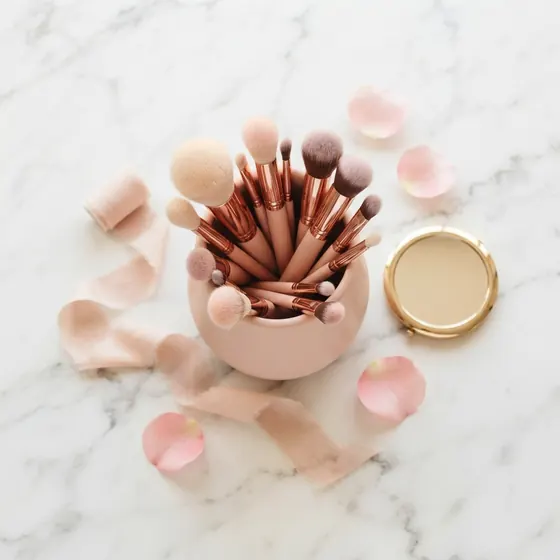 Professional makeup brush set laid out at Glowing Nest